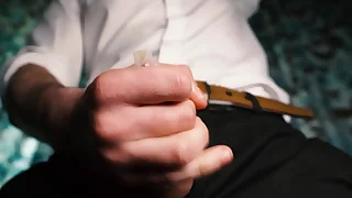 Titillating guy in a suit jerks off close-up, moans about pleasure and cums in a condom.
